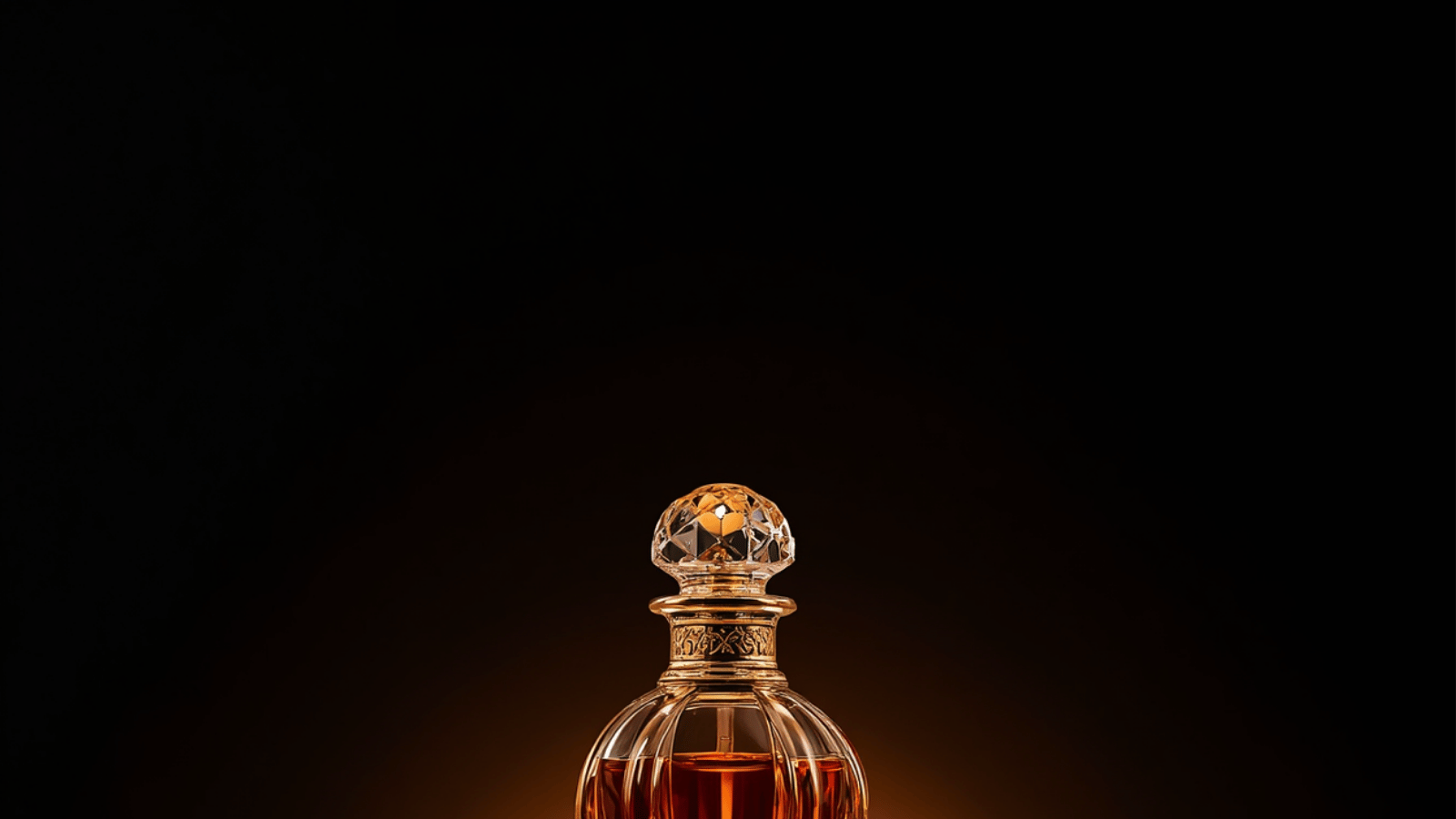 A crystal attar bottle glowing with amber perfume oil